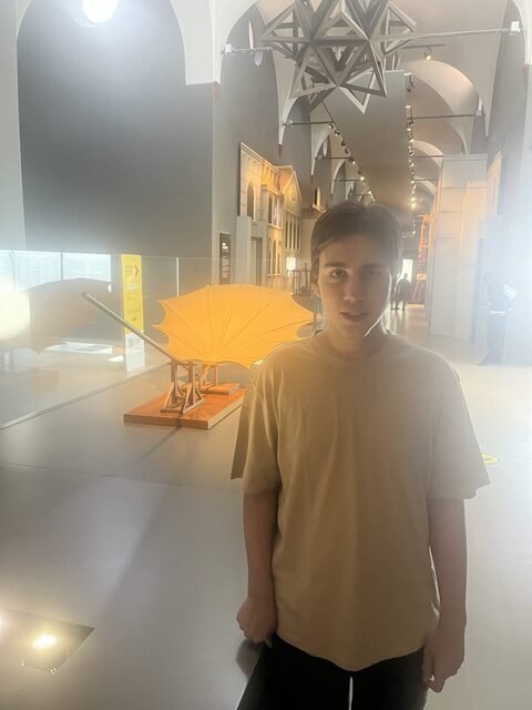 Demir in front of a flying machine model