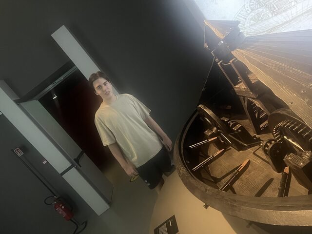 Demir beside the inner mechanism of the tank model