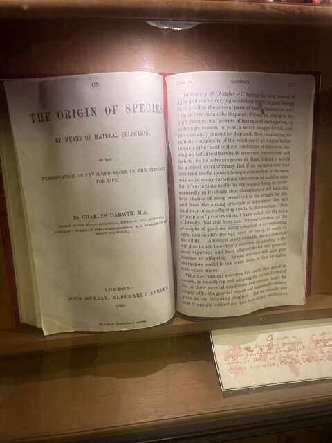 Open first edition of On the Origin of Species in a display case