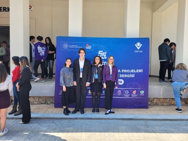Group photo in front of the exhibition banner