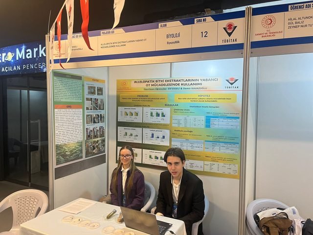 Two students at the project stand